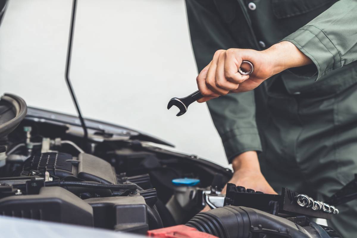 Ballengers Service Center Service page Professional mechanic hand providing car repair and maintenance service in auto garage. Car service business concept.
